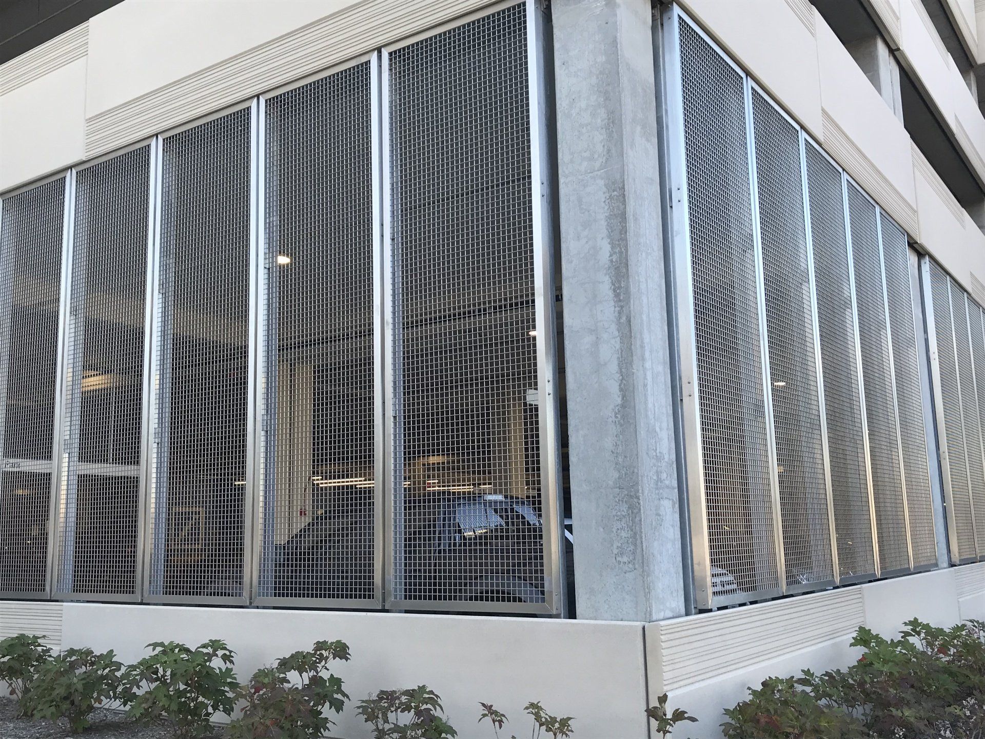 A building with a lot of windows and a car parked in it