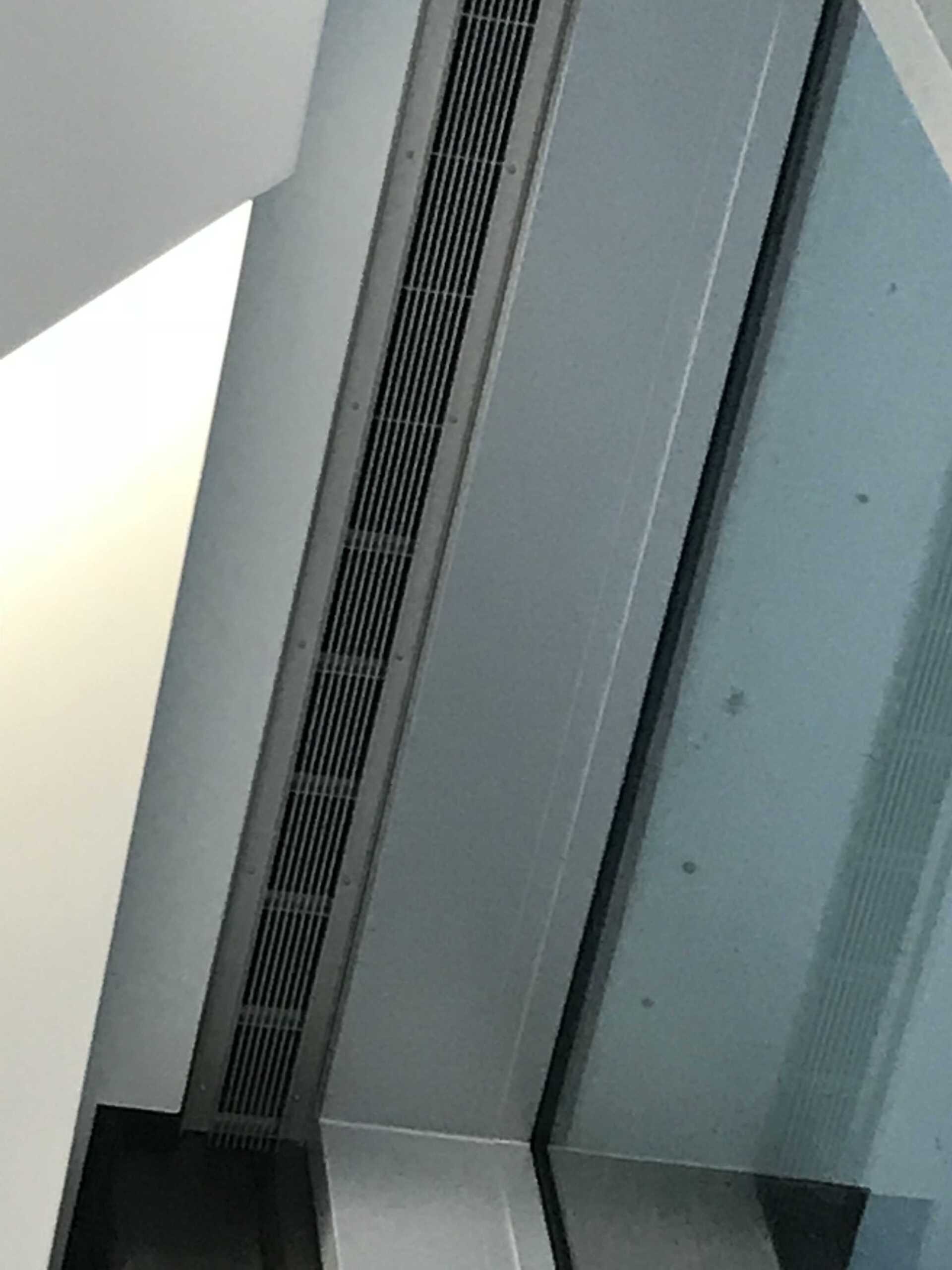 A close up of a window with a grille on it