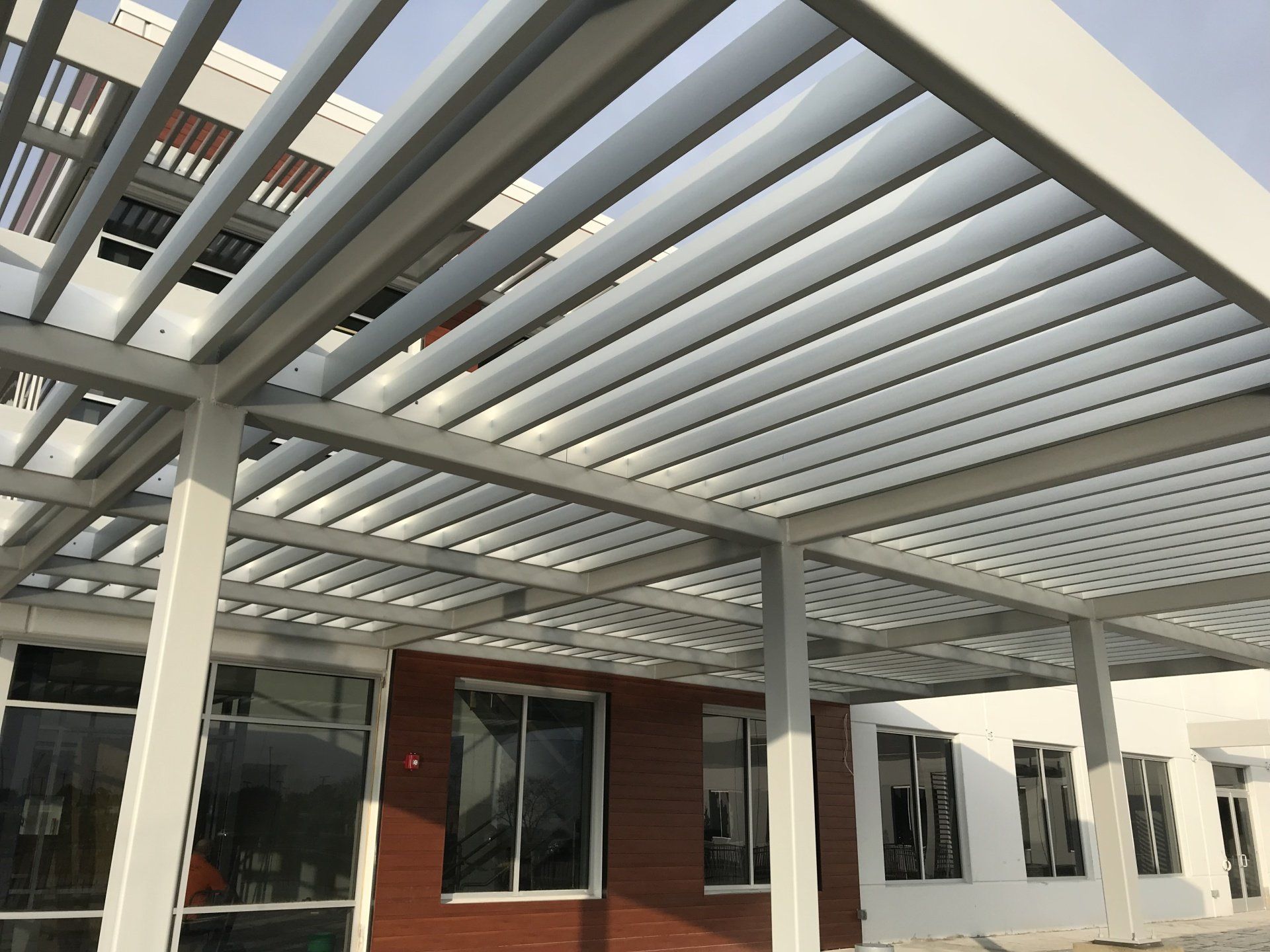 A building with a pergola and a lot of windows