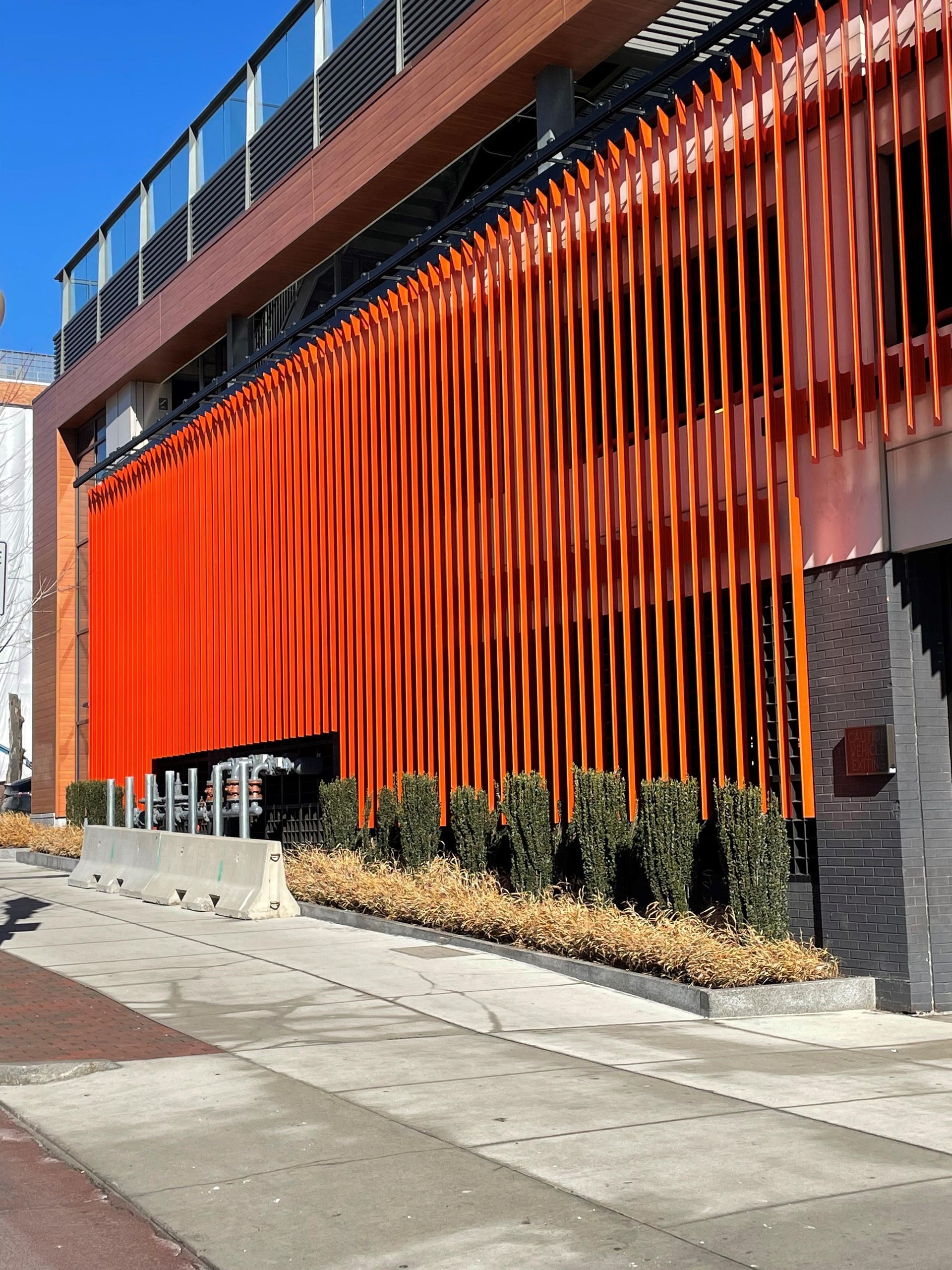 A large orange building with a fence around it