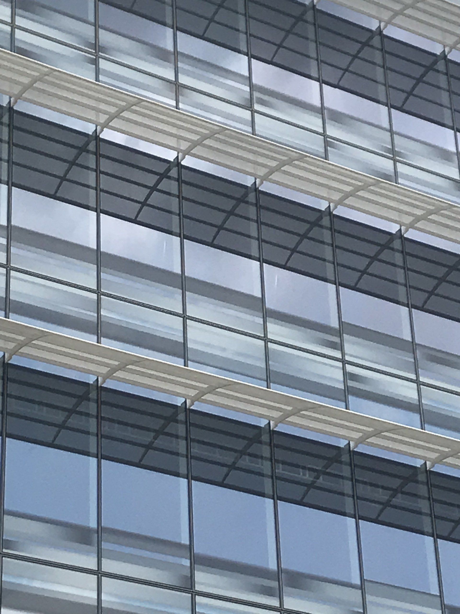 A building with a lot of windows and a blue sky in the background