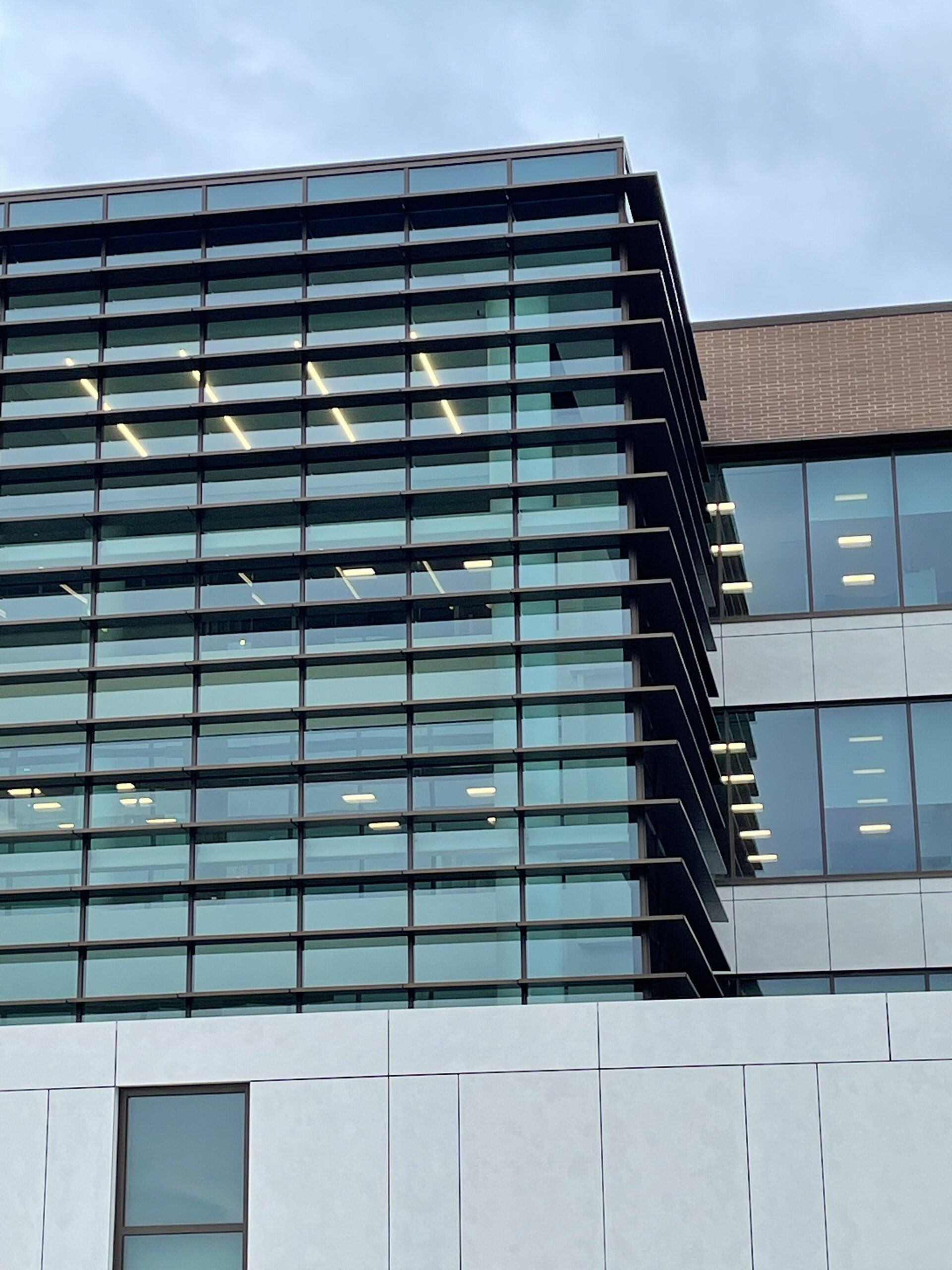 A building with a lot of windows and a blue sky in the background