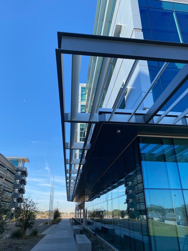 A large glass building with a canopy over it