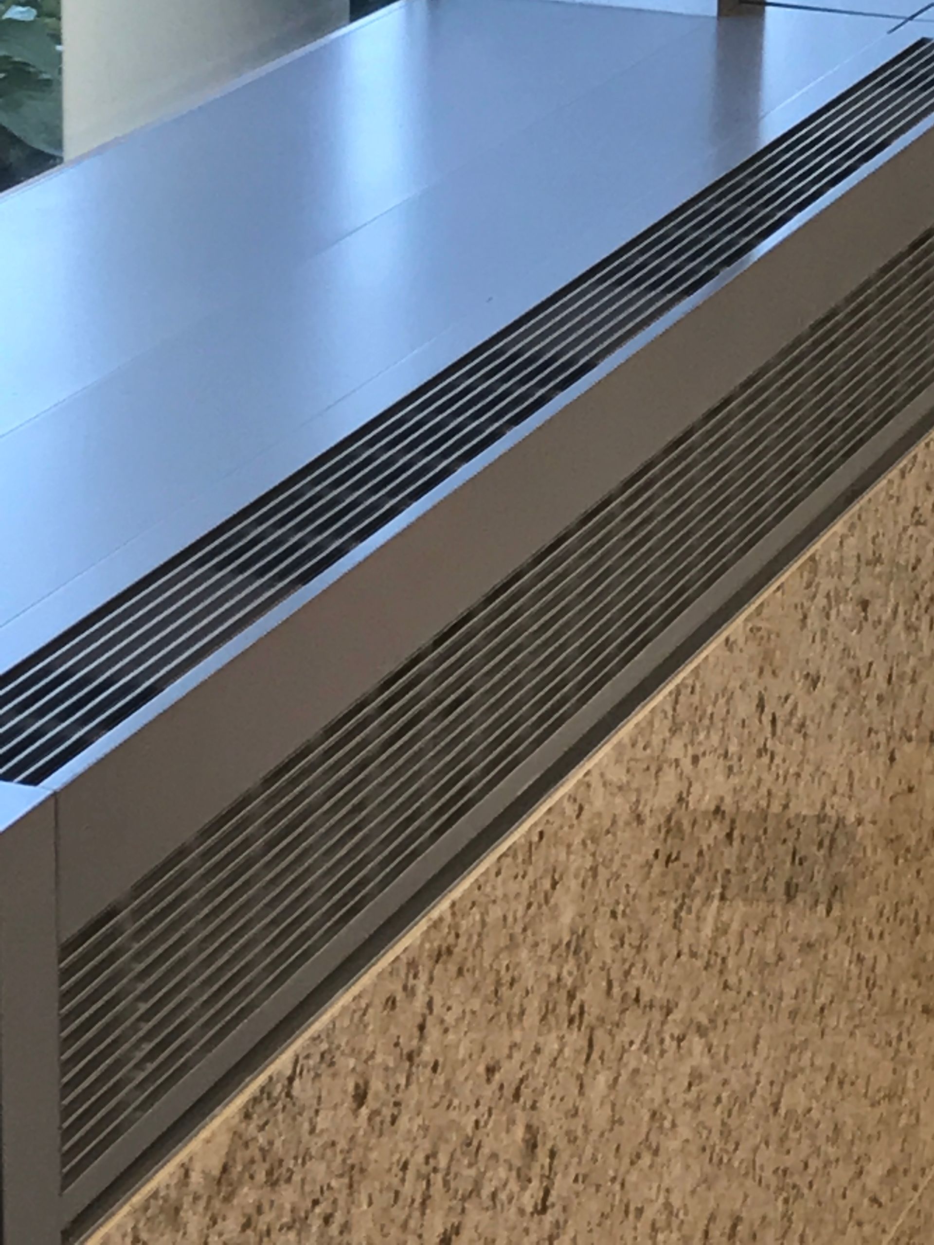 A metal box with a grille on the side of it