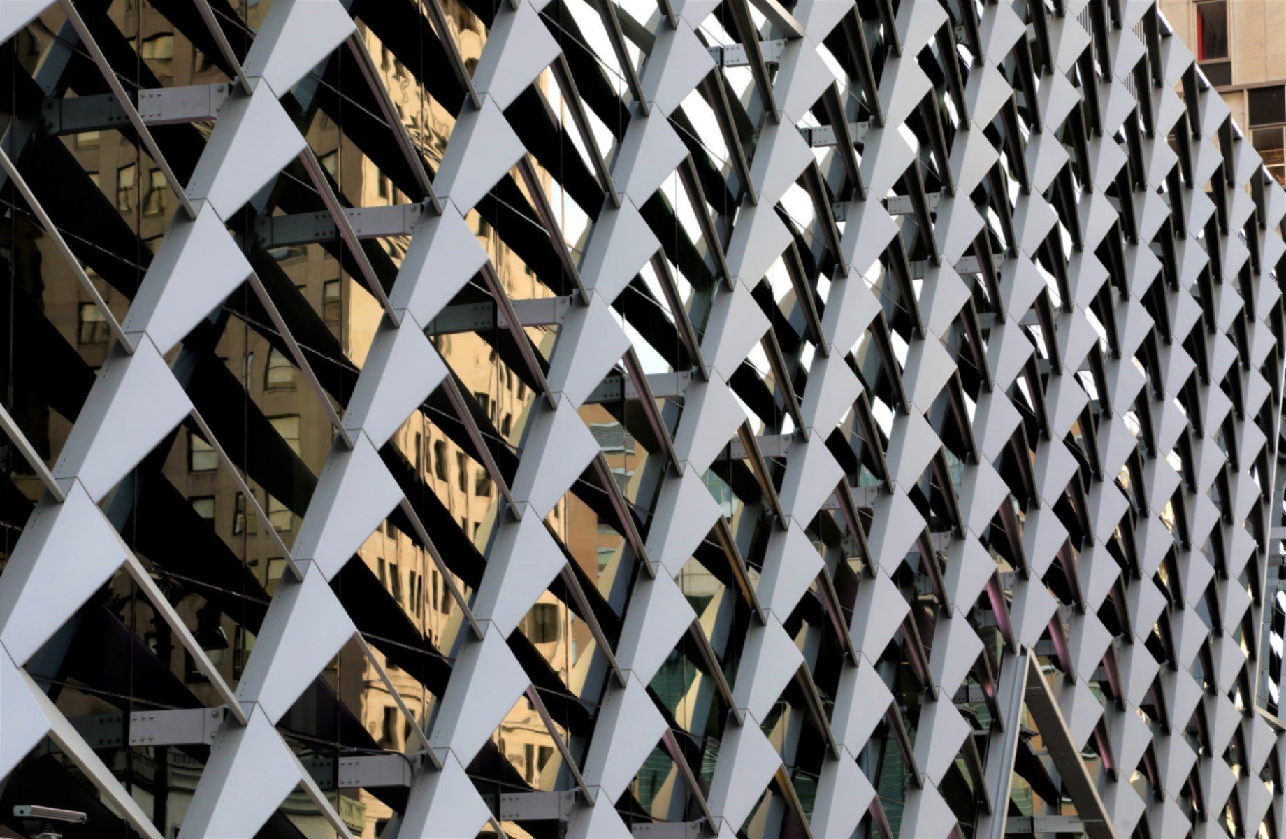 A close up of a metal fence with a geometric pattern on it.