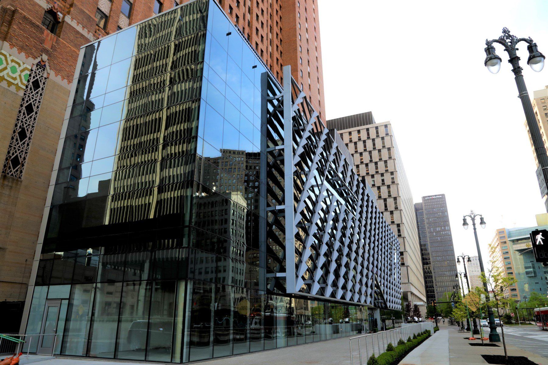 A large building with a lot of windows is surrounded by other buildings