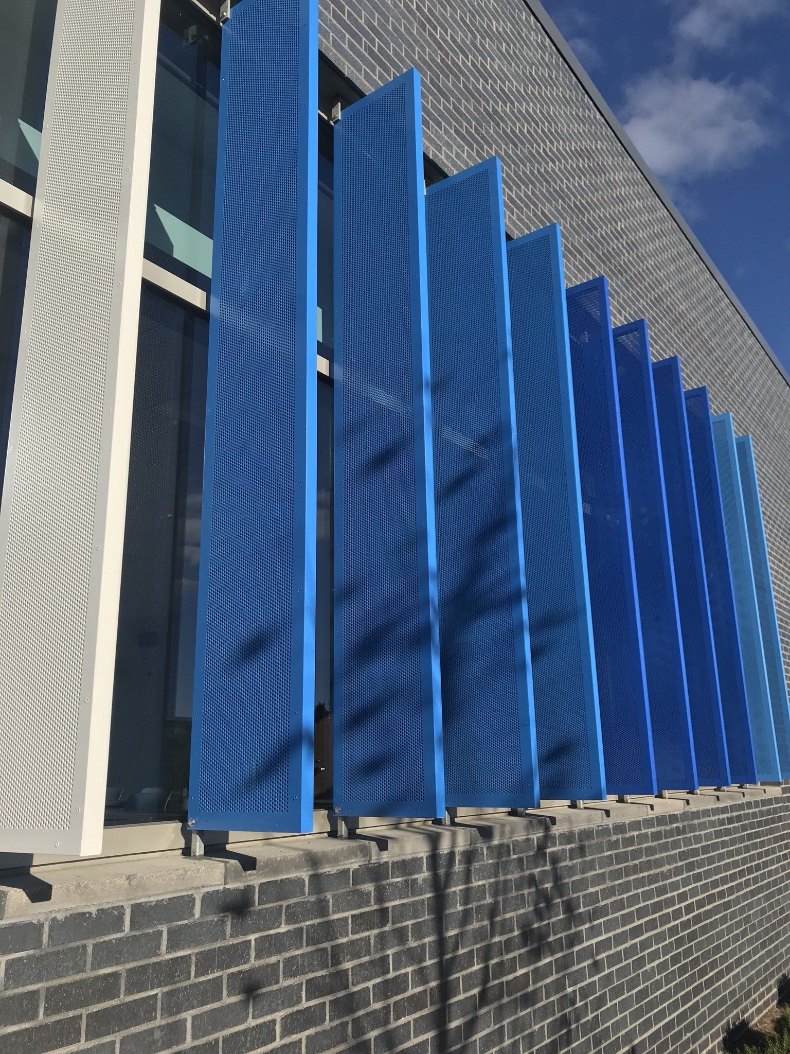 A building with blue shutters on the side of it