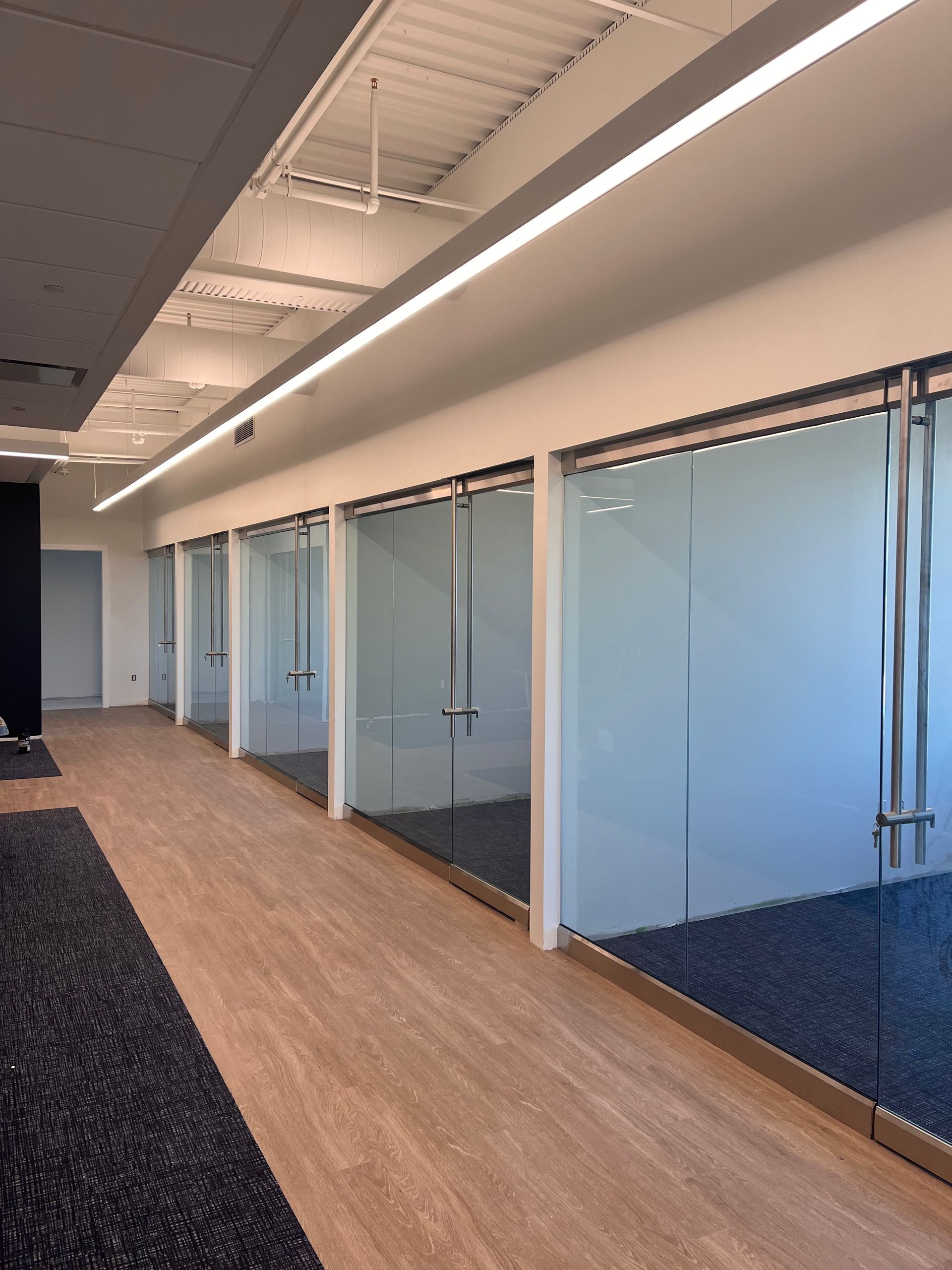 A long hallway with a lot of glass doors