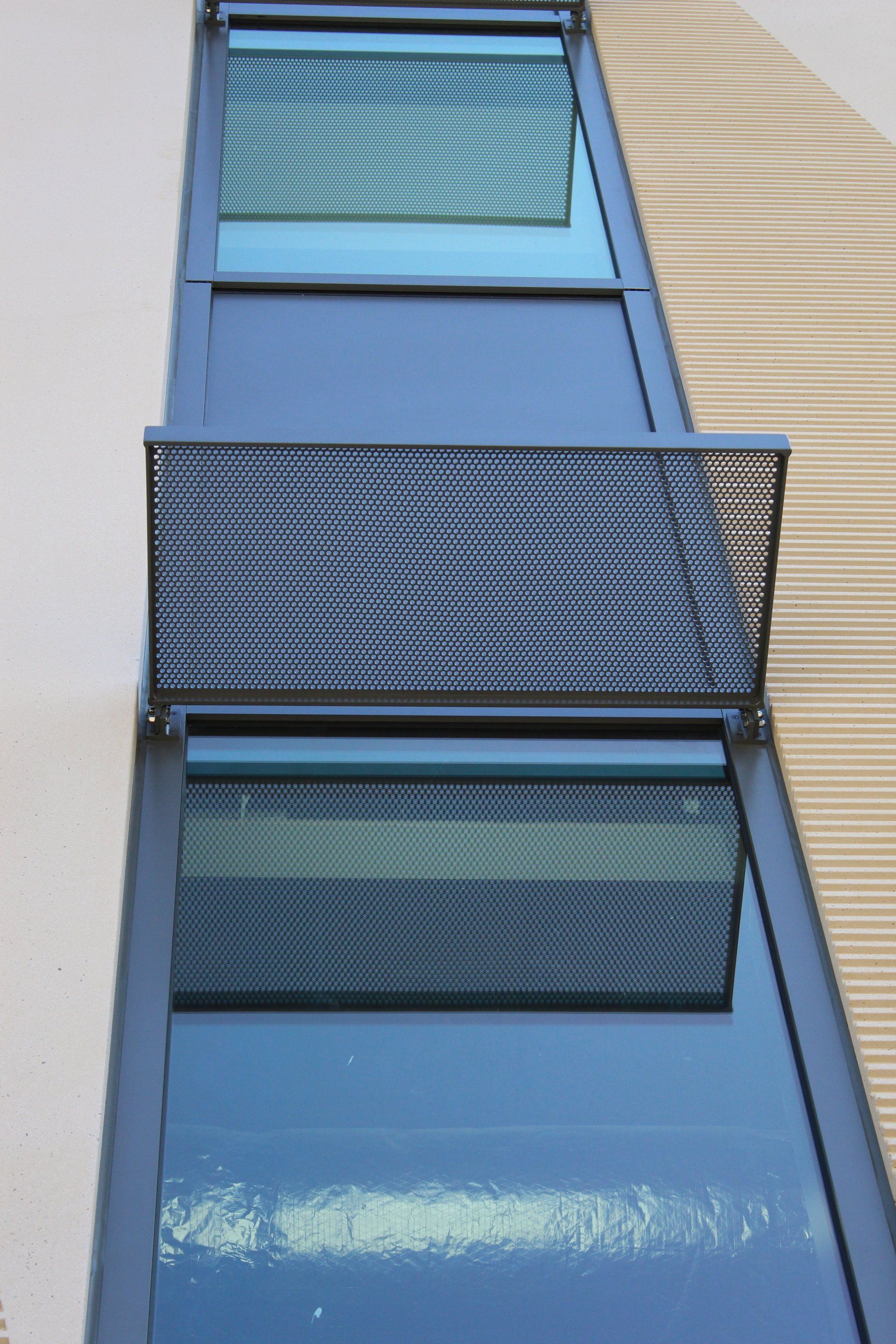 A building with a reflection of trees in the windows