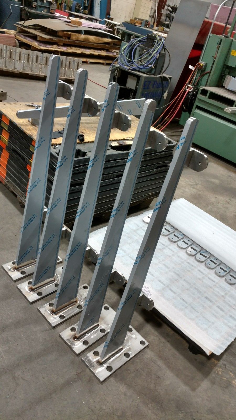 A bunch of metal poles sitting on top of a table in a factory.