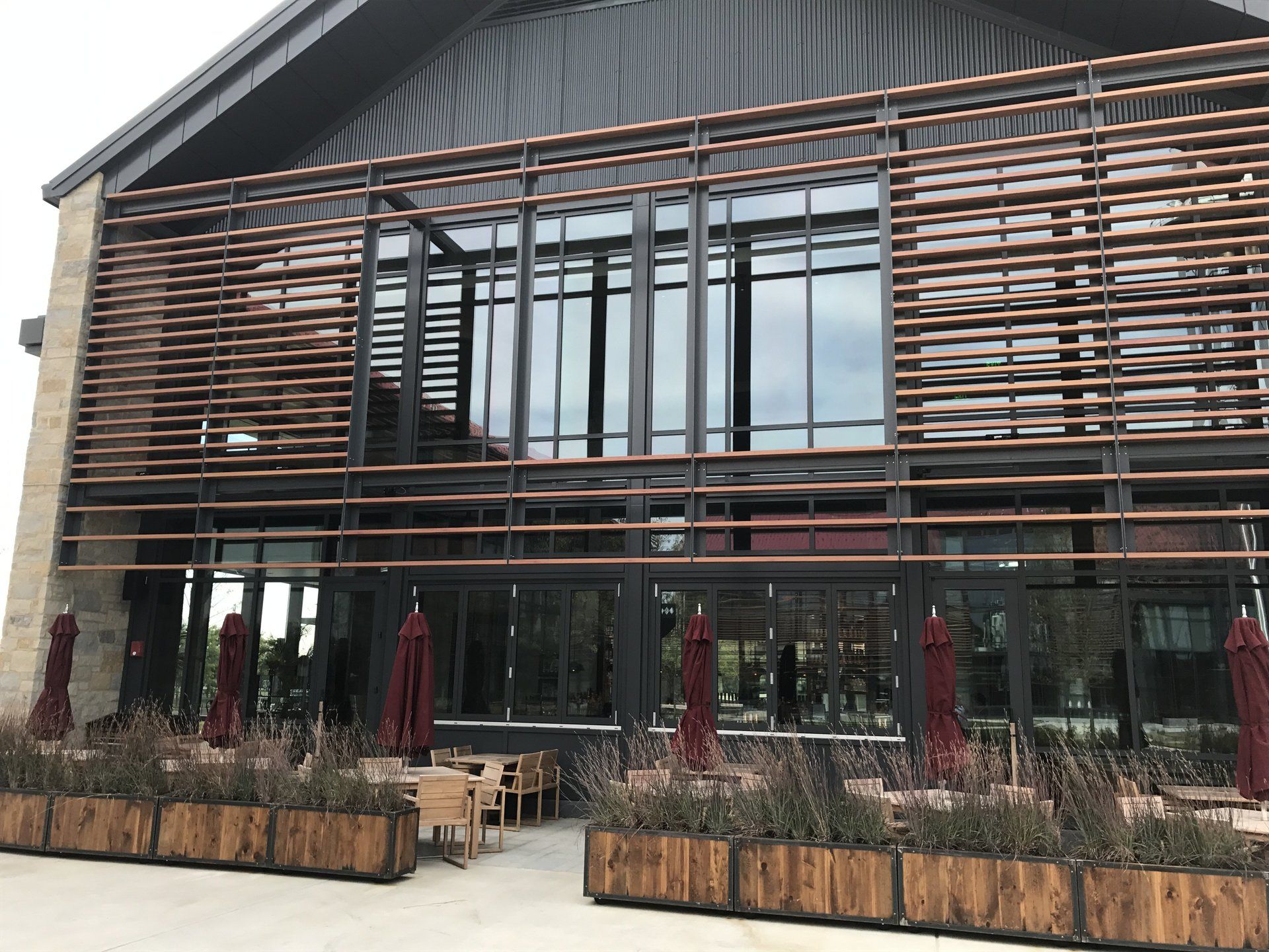 A large building with a lot of windows and umbrellas