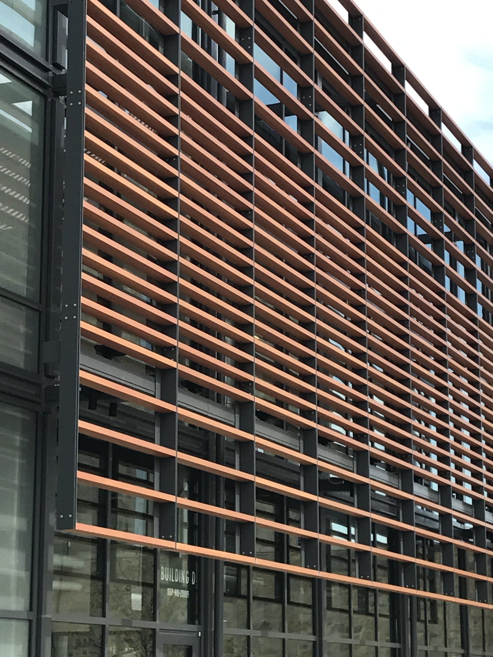 A building with a lot of windows and a wooden facade