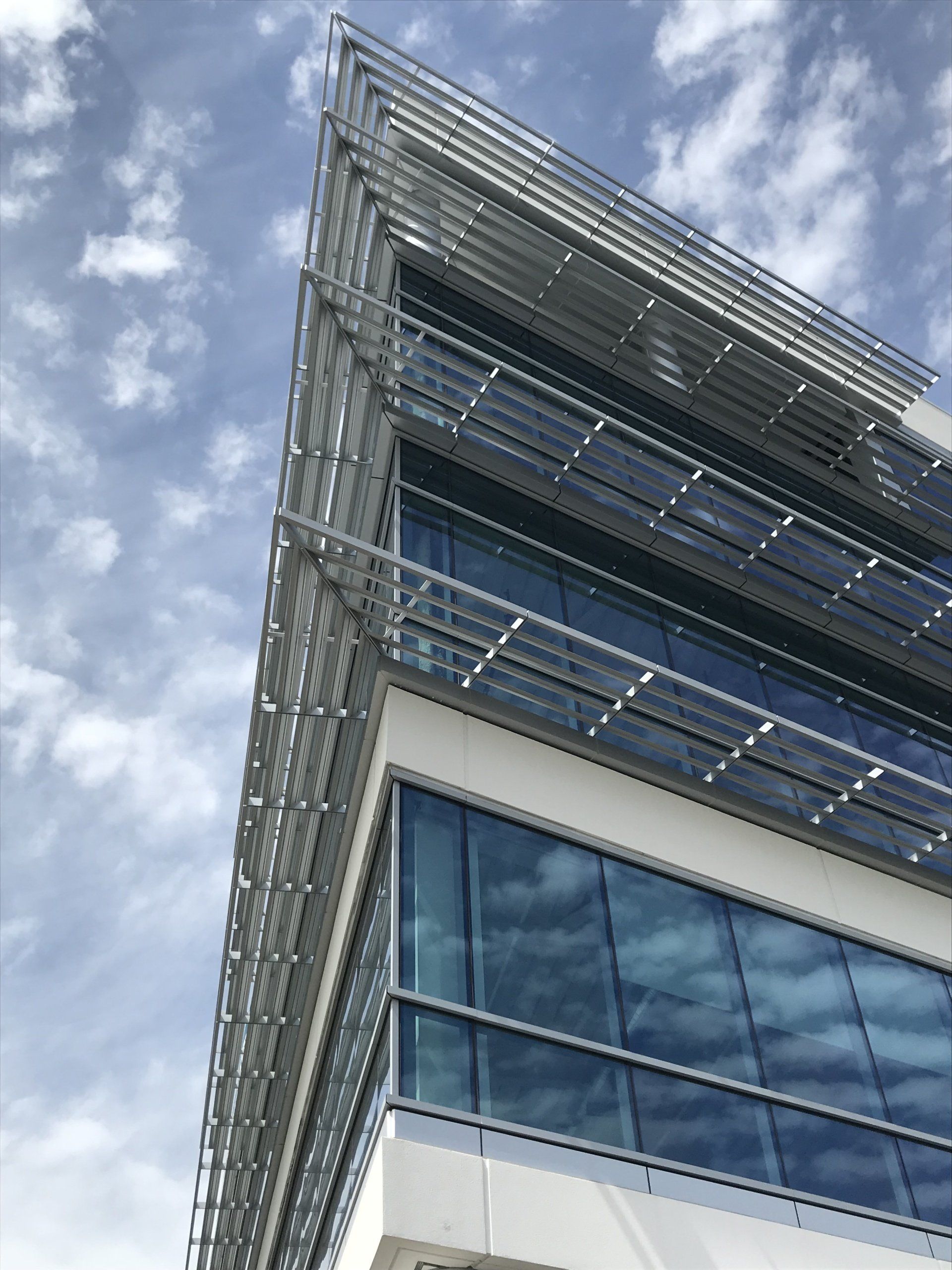 Looking up at a tall building with a blue sky in the background