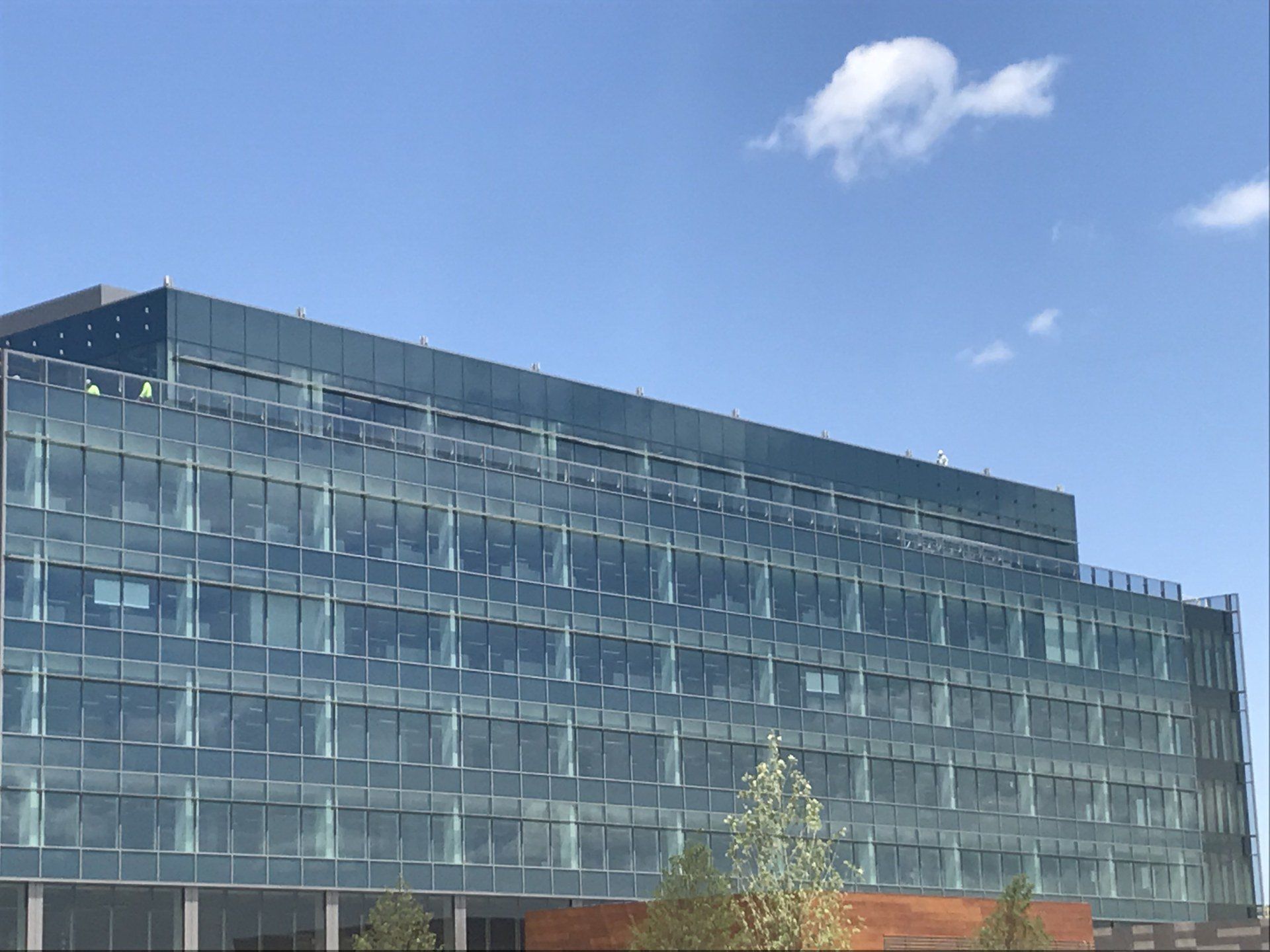 A large building with a lot of windows and a blue sky in the background