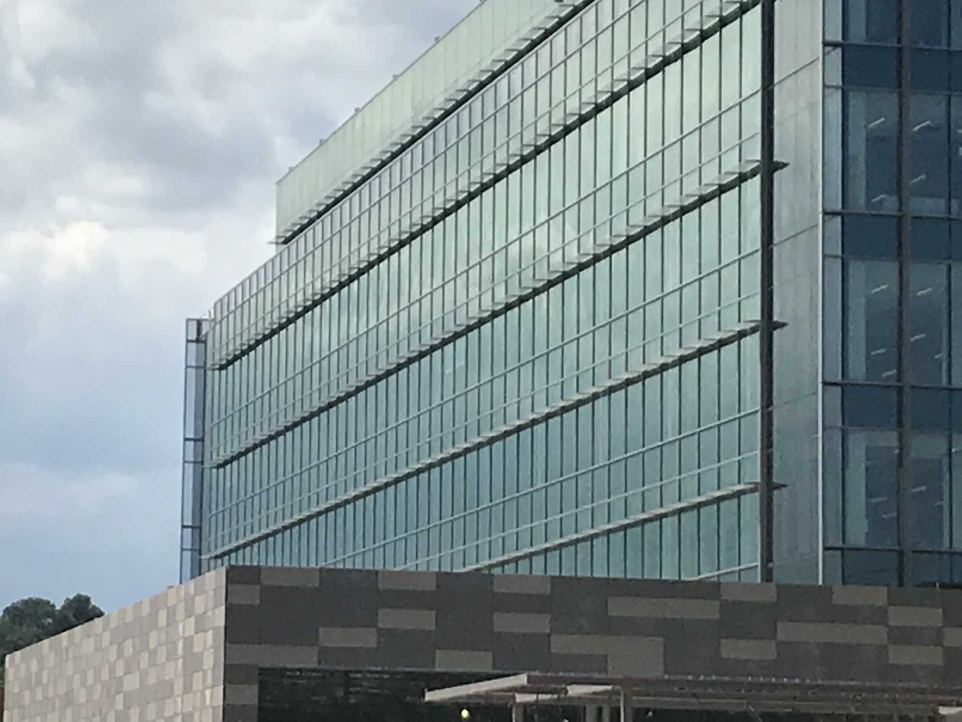 A large building with a lot of windows on a cloudy day.