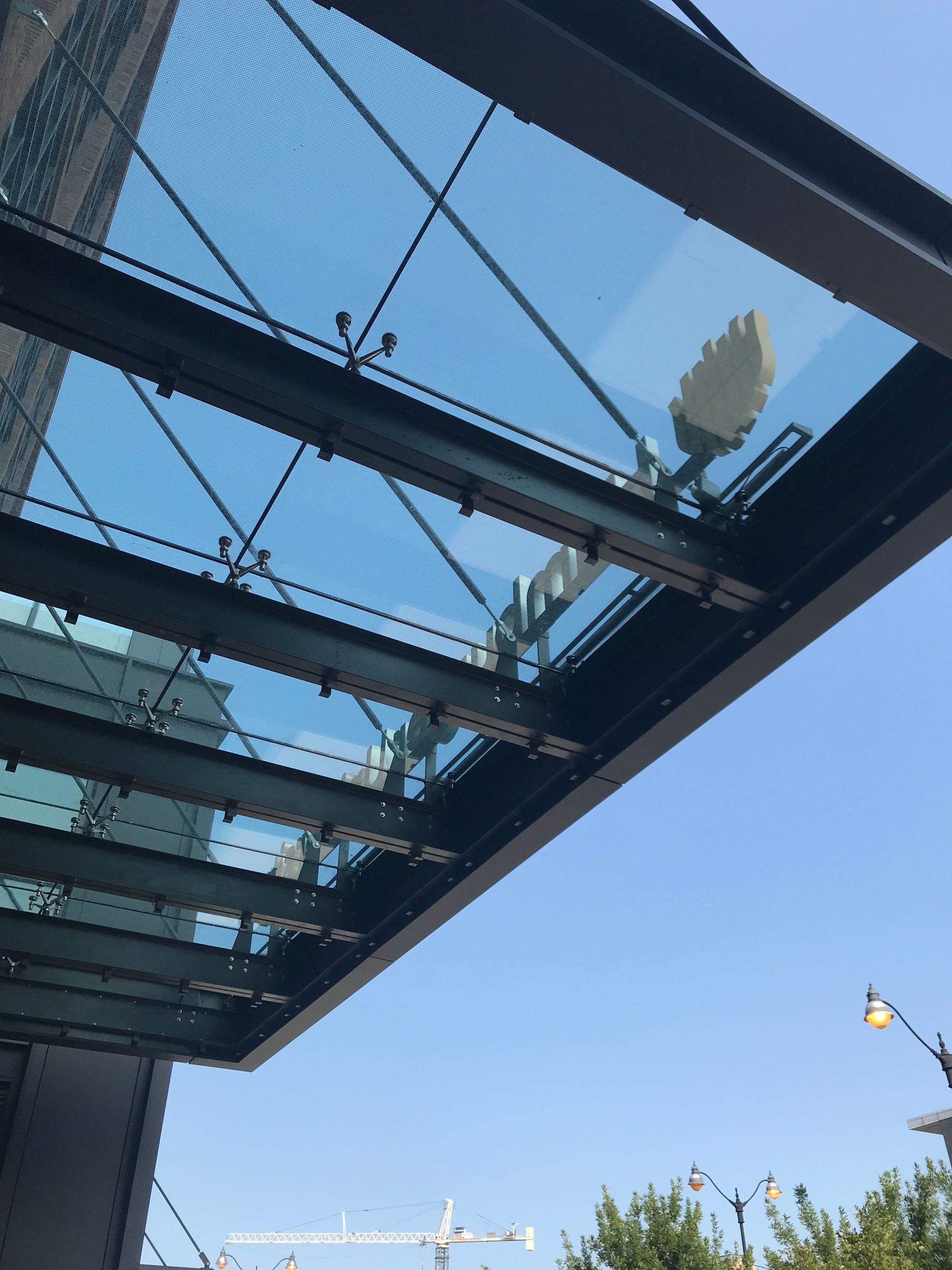 A glass roof with a blue sky behind it
