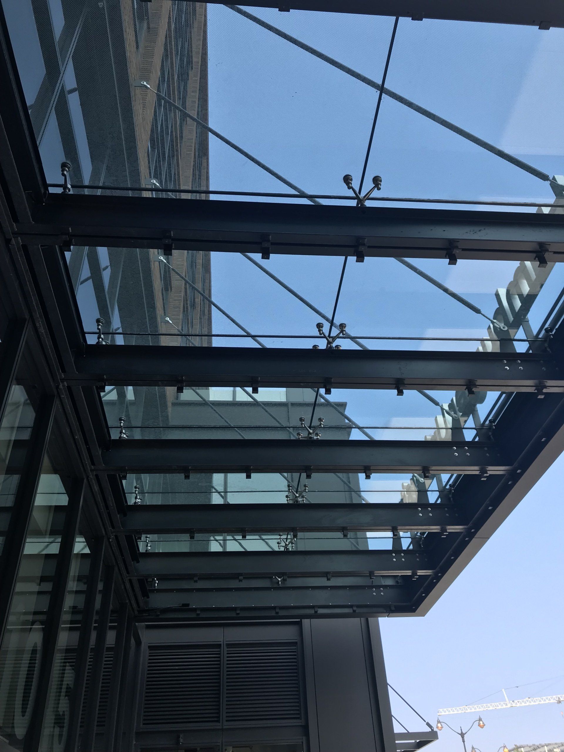 A building with a glass roof and a blue sky in the background