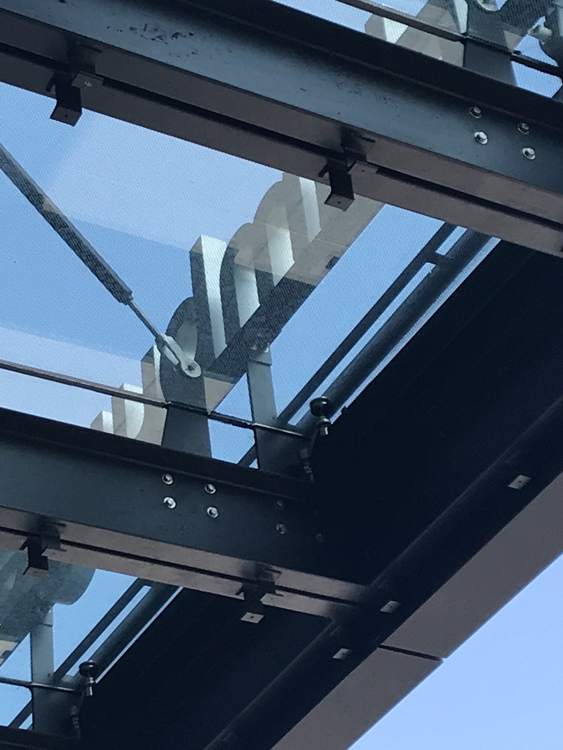 A metal structure with a clear glass roof