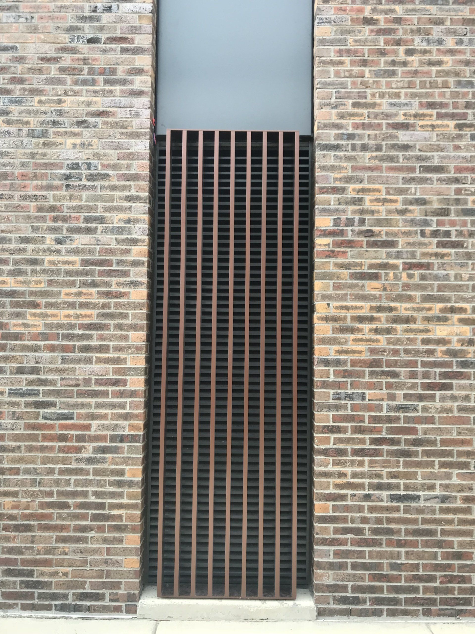 A brick wall with a wooden fence in front of it