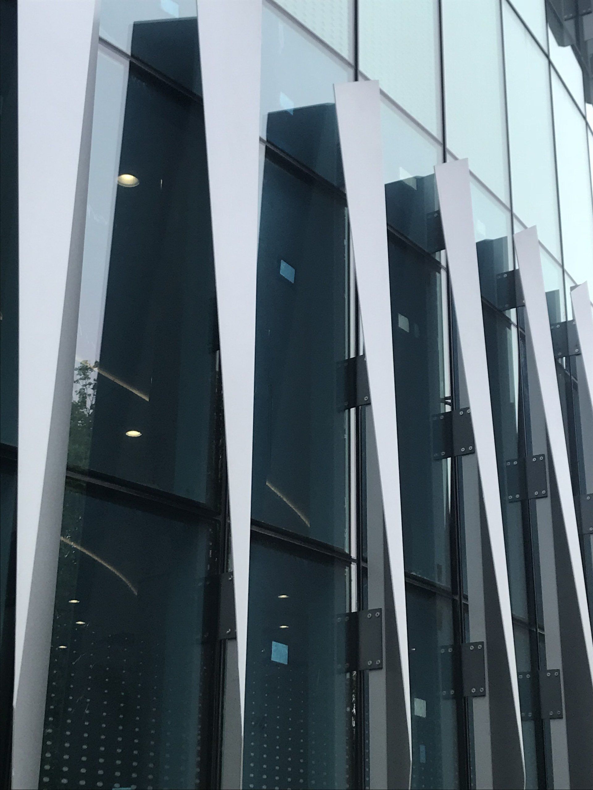 A building with a lot of windows and a white sculpture