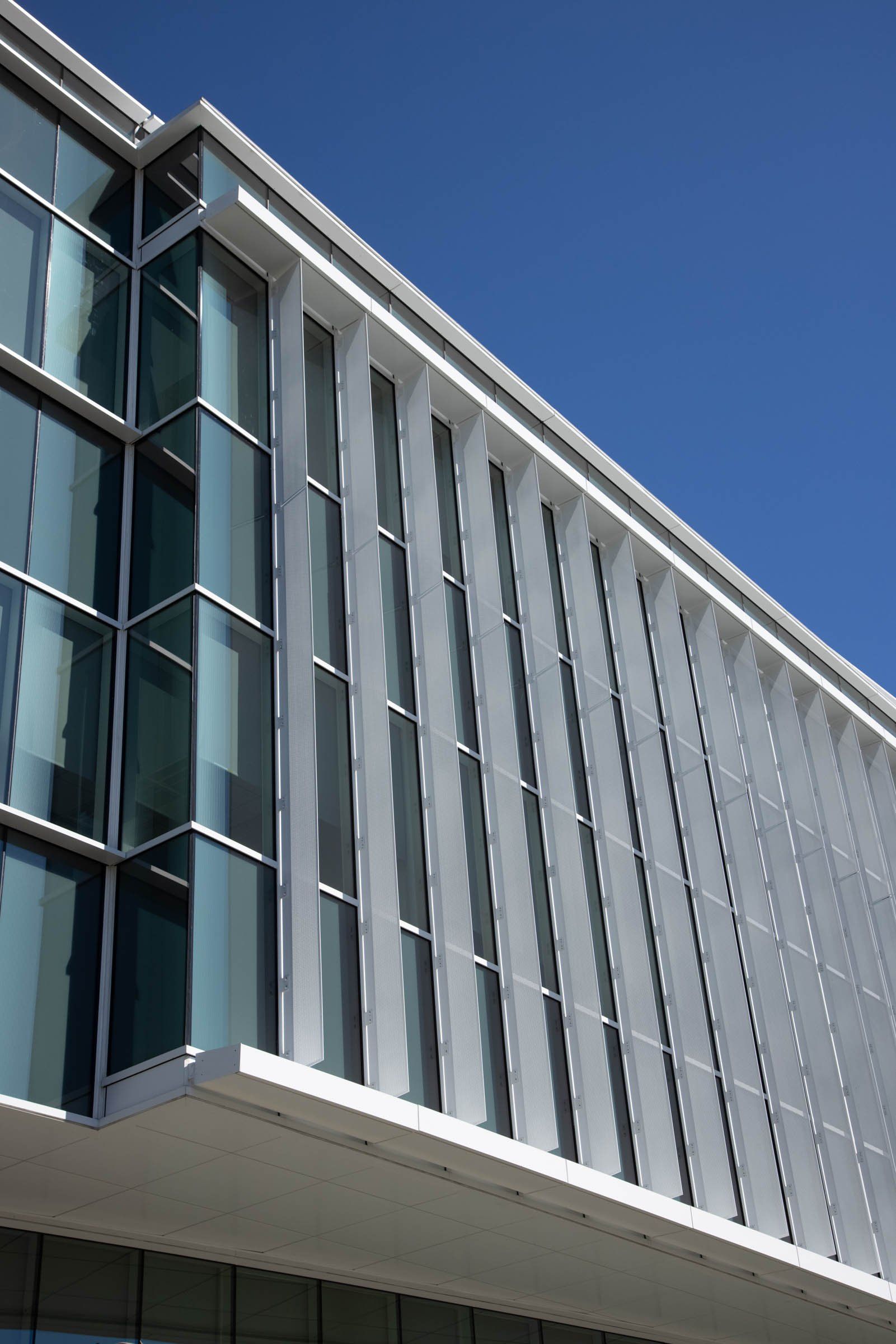 A building with a lot of windows and a blue sky in the background