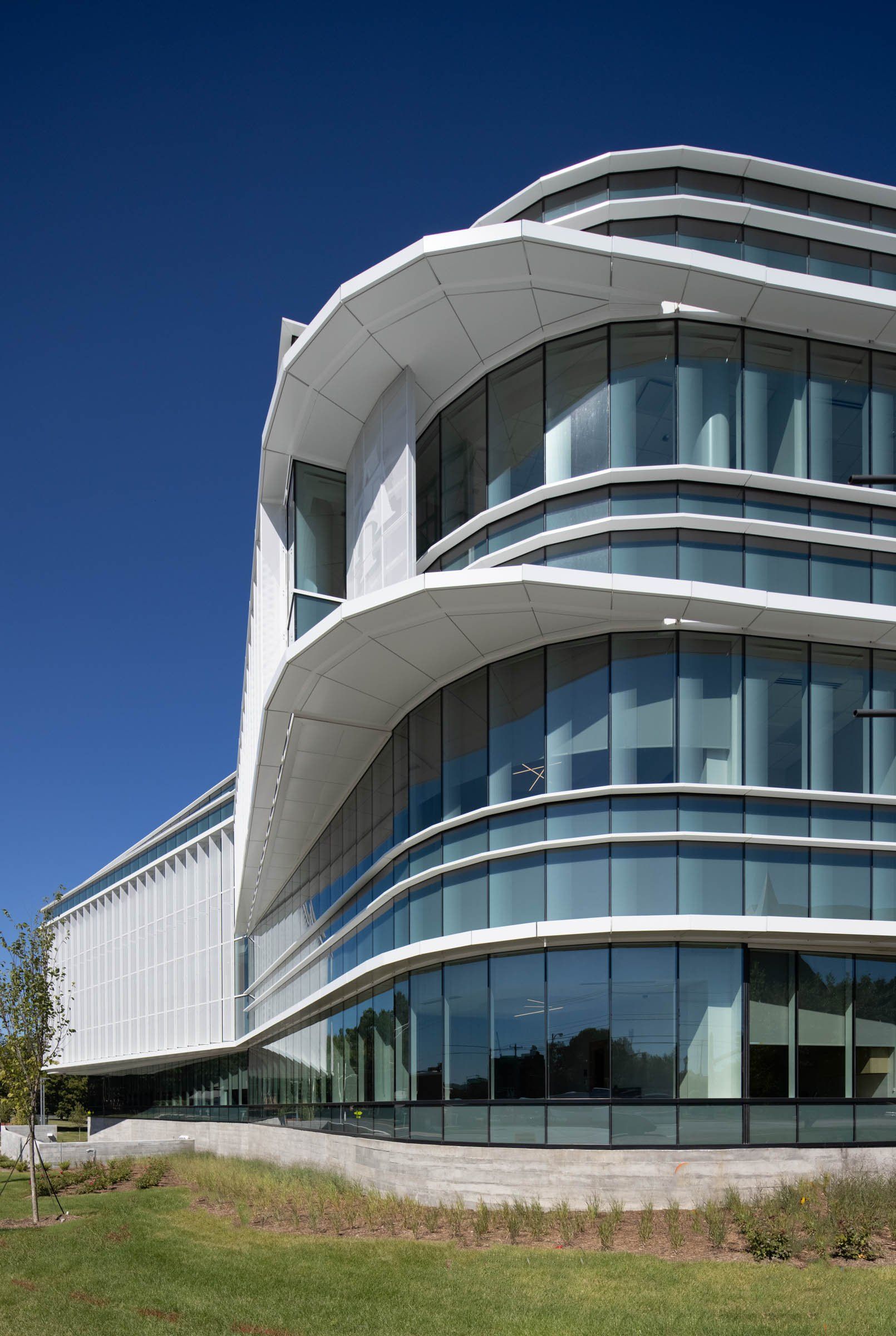 A large curved building with a lot of windows