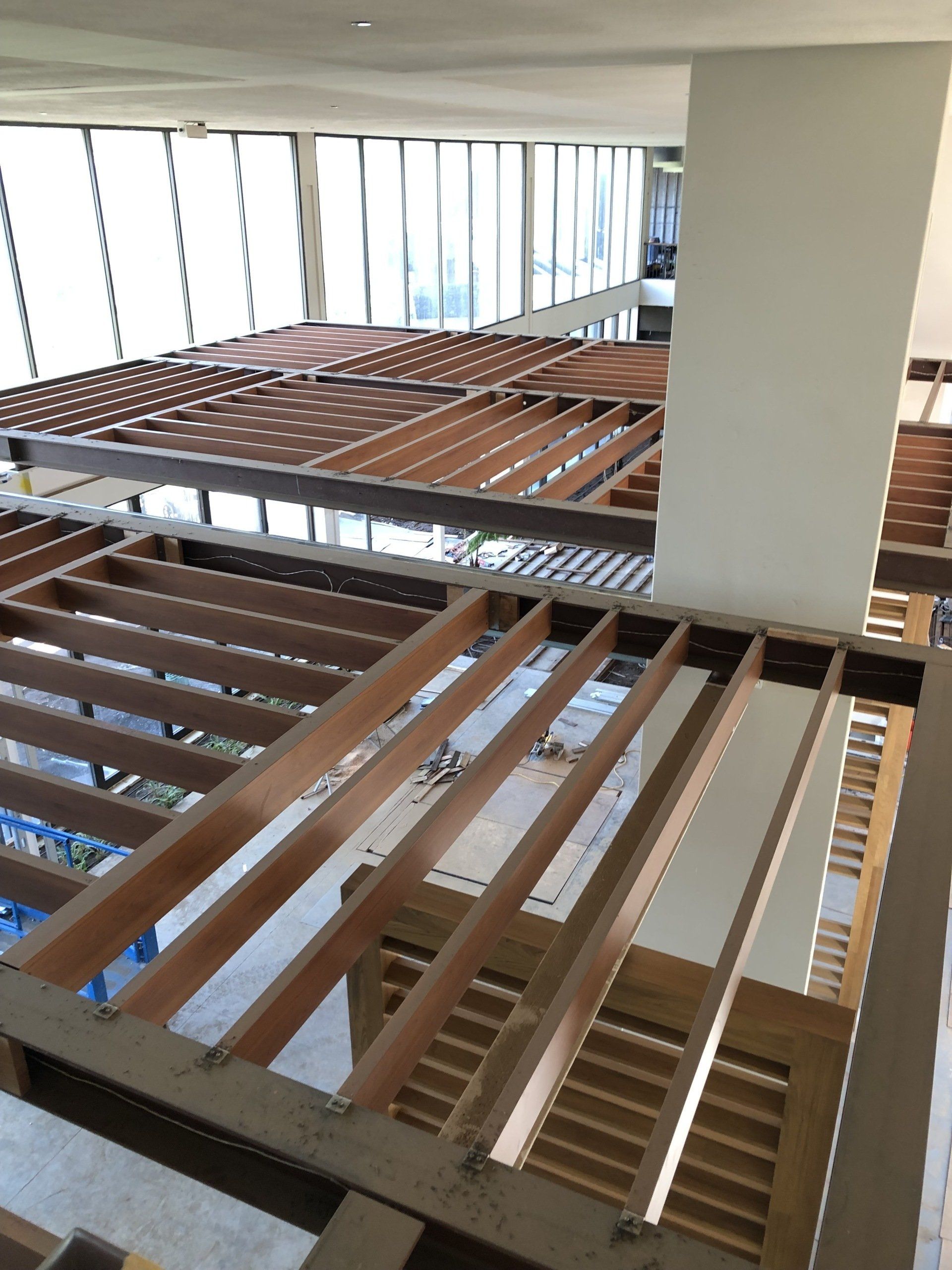 A large room with lots of windows and wooden beams