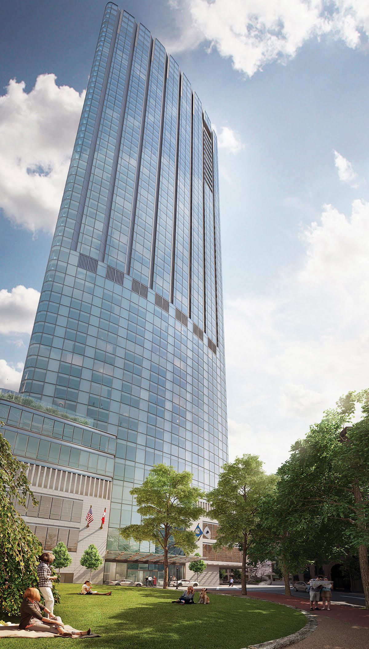 A tall building with a lot of windows is surrounded by trees and grass.