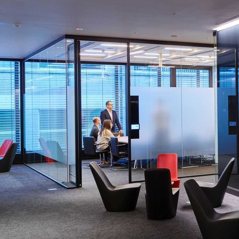 A group of people are having a meeting in a conference room