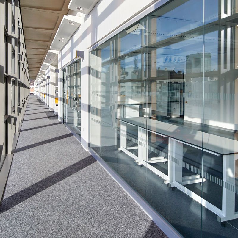 A long hallway in a building with a lot of windows