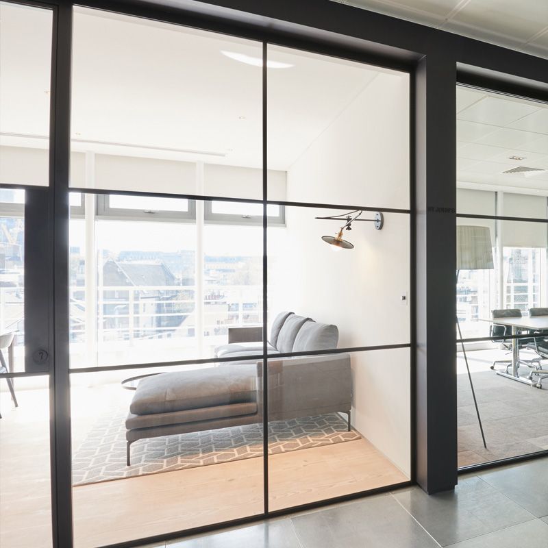 A living room with a couch and a large window