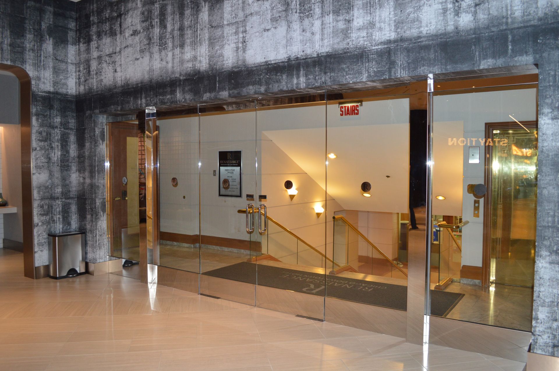 A building with a lot of glass doors and stairs