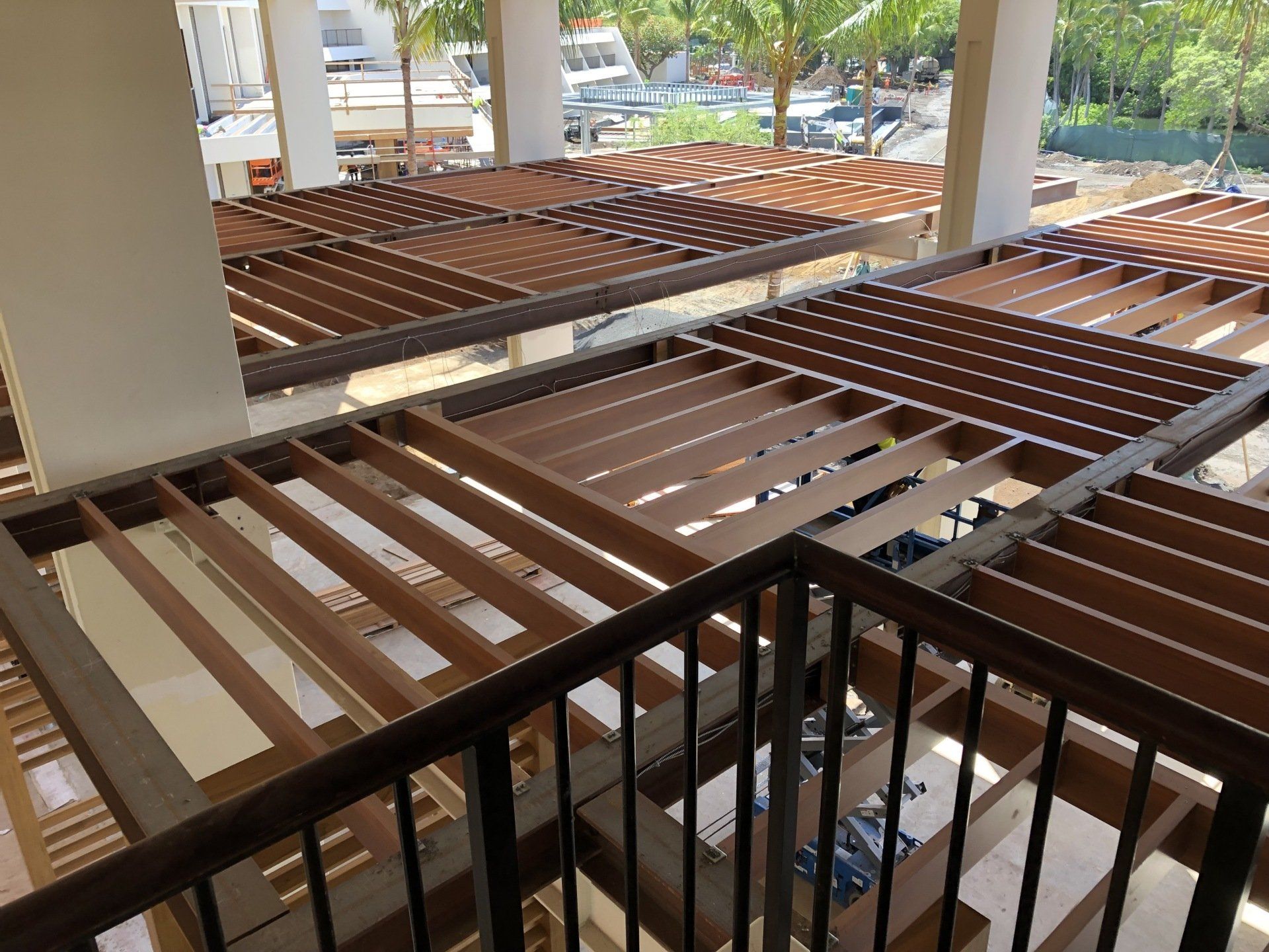 A balcony with a wooden pergola and a metal railing