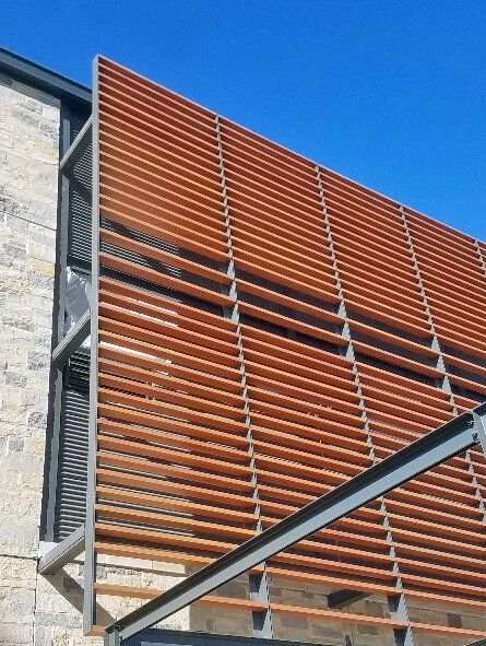 A building with a wooden fence on the side of it.