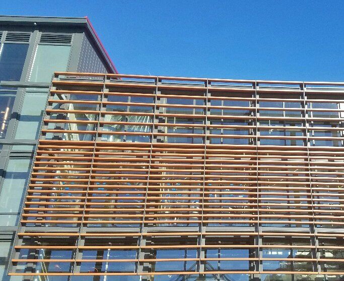 A building with a lot of windows and a wooden fence