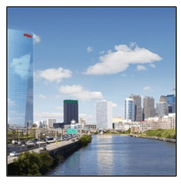 A city skyline with a river in the foreground