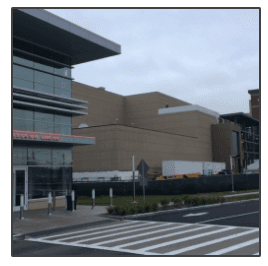 A large building with a red sign that says ' emergency room ' on it