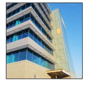 A building with a lot of windows and a blue sky in the background