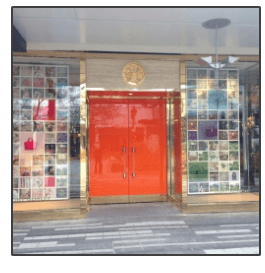 Tory burch store front with a red door