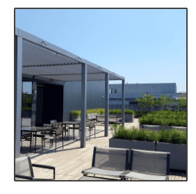 A patio with tables and chairs under a pergola