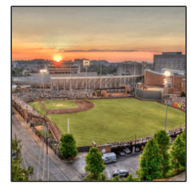 An aerial view of a baseball stadium at sunset