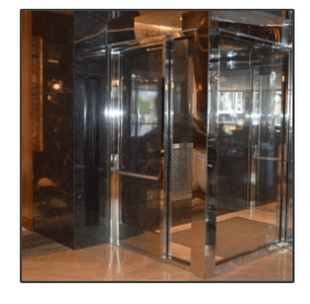 A stainless steel elevator with a glass door