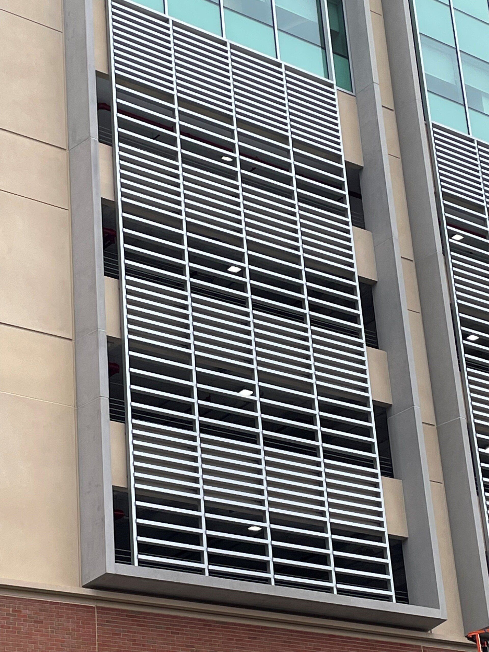 A building with a lot of windows and a lot of shutters on it