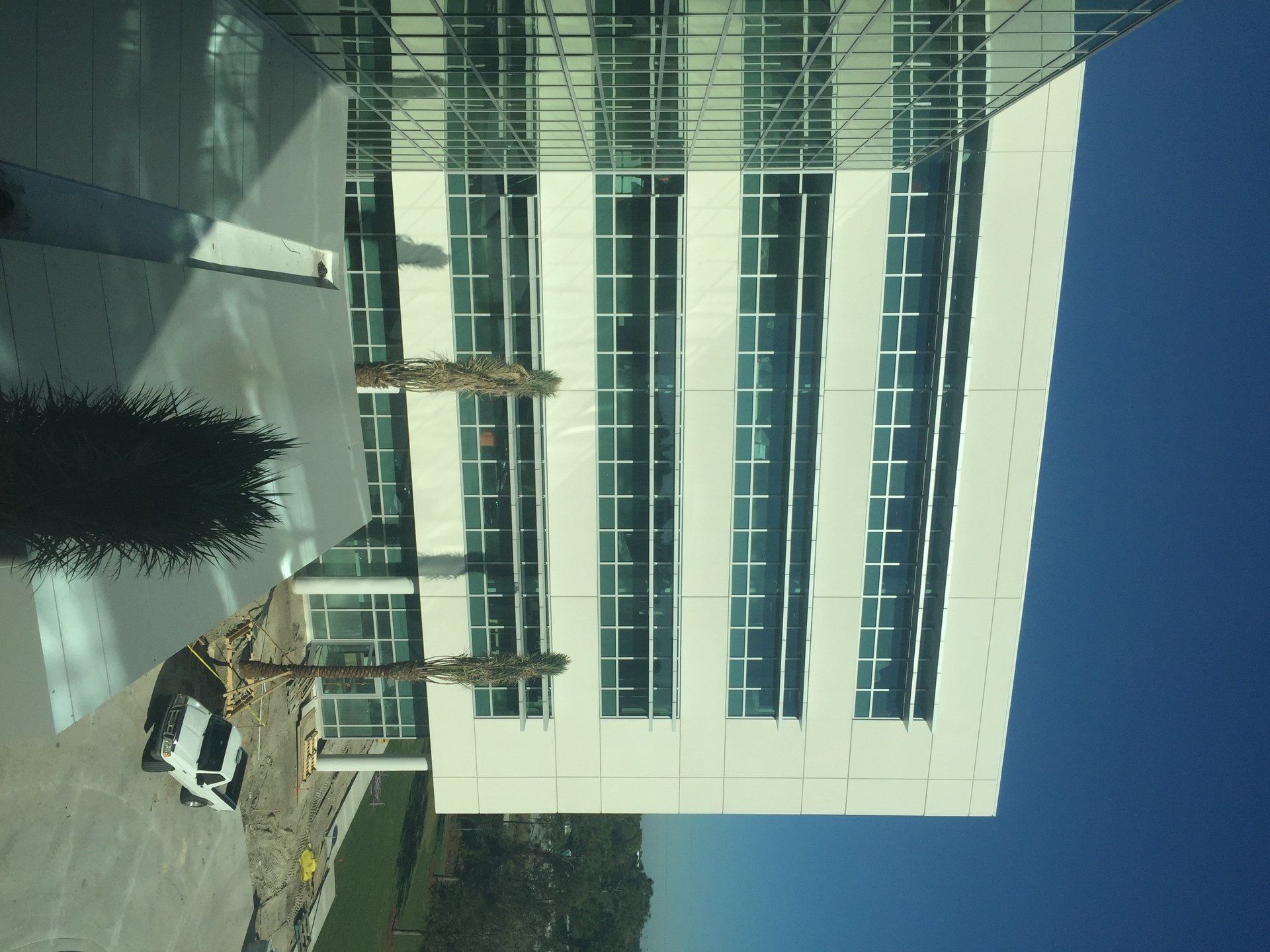 A building with a lot of windows and a blue sky in the background