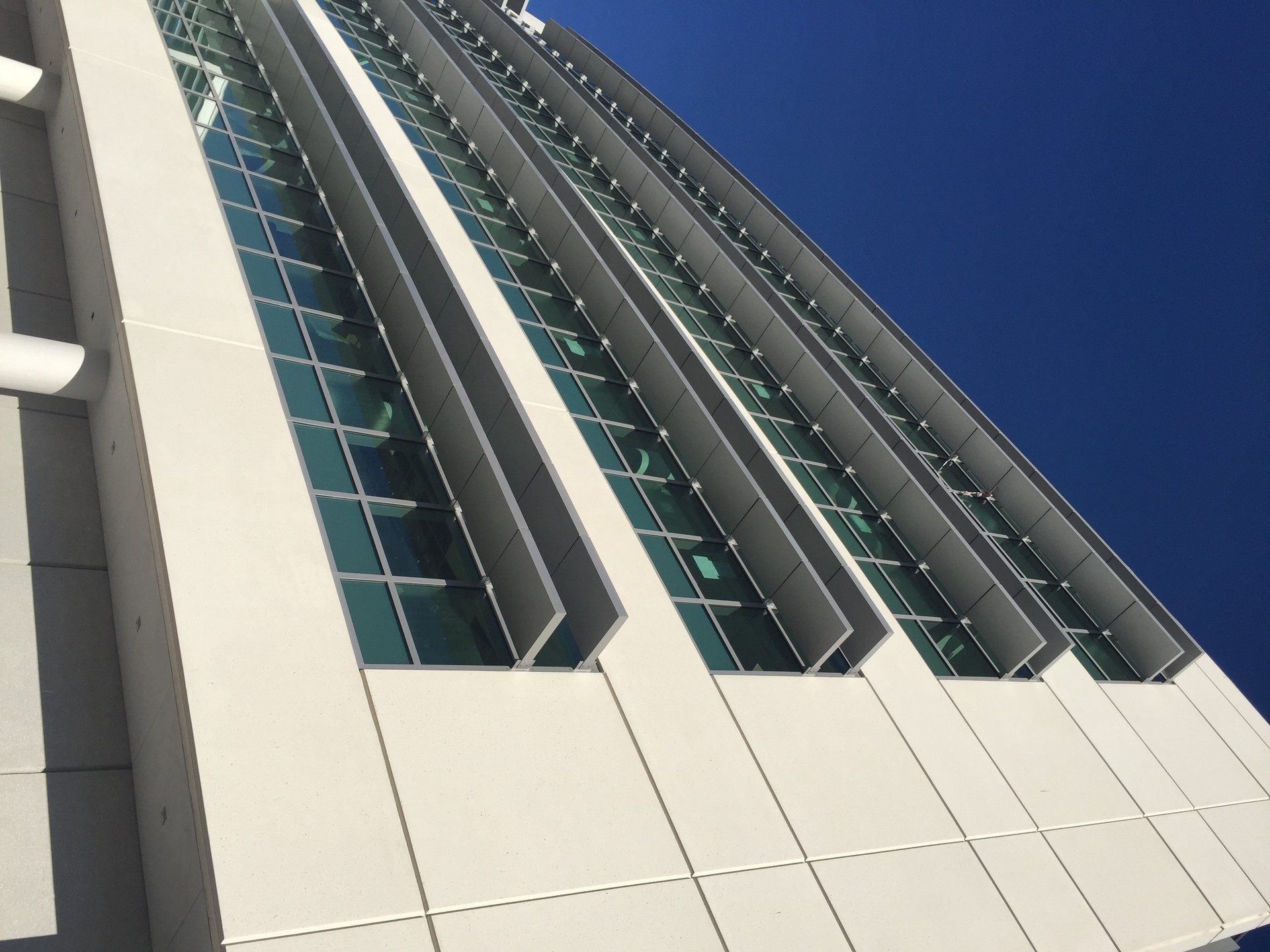 Looking up at a tall building with a blue sky in the background