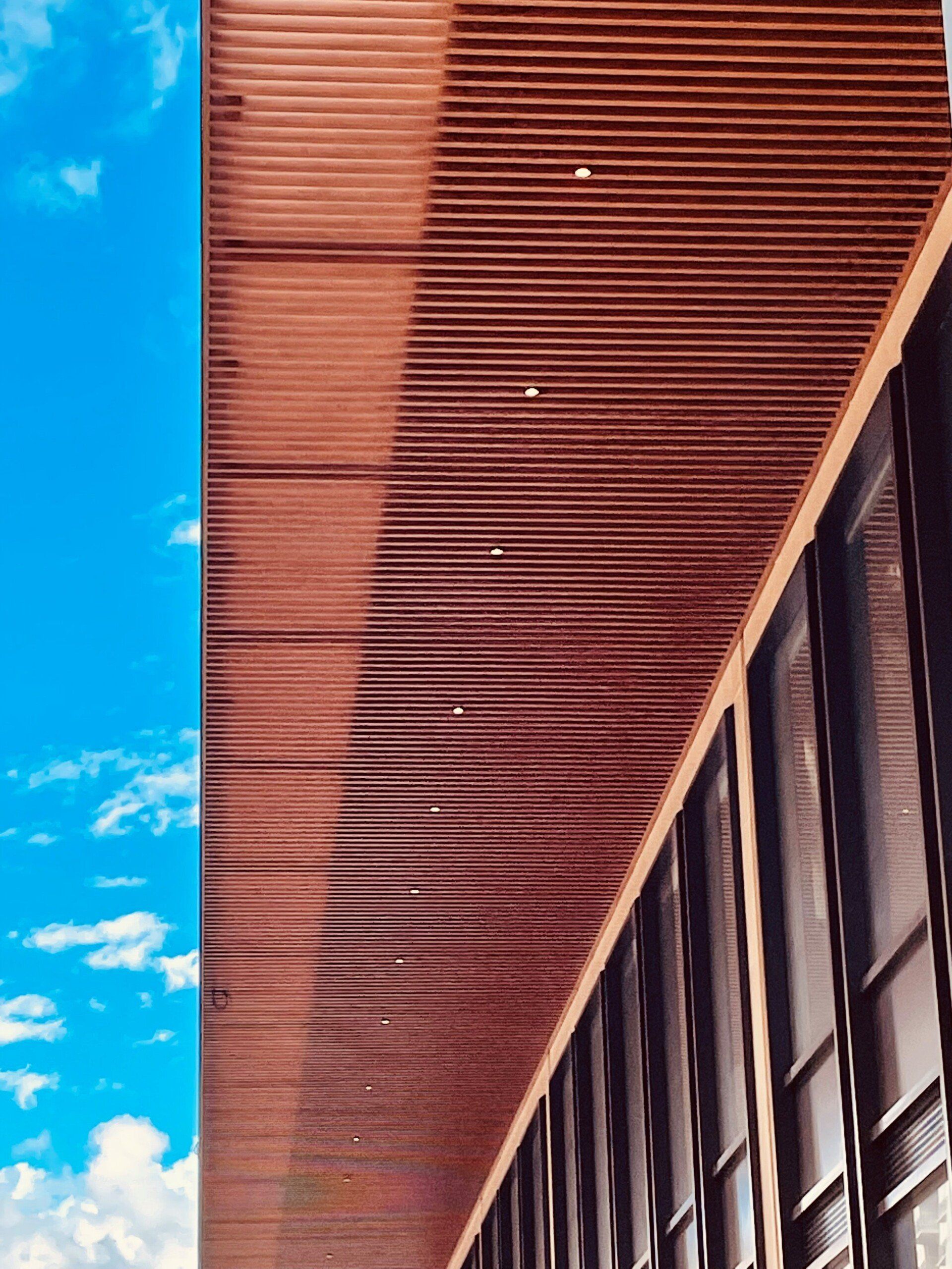 A building with a lot of windows and a blue sky in the background