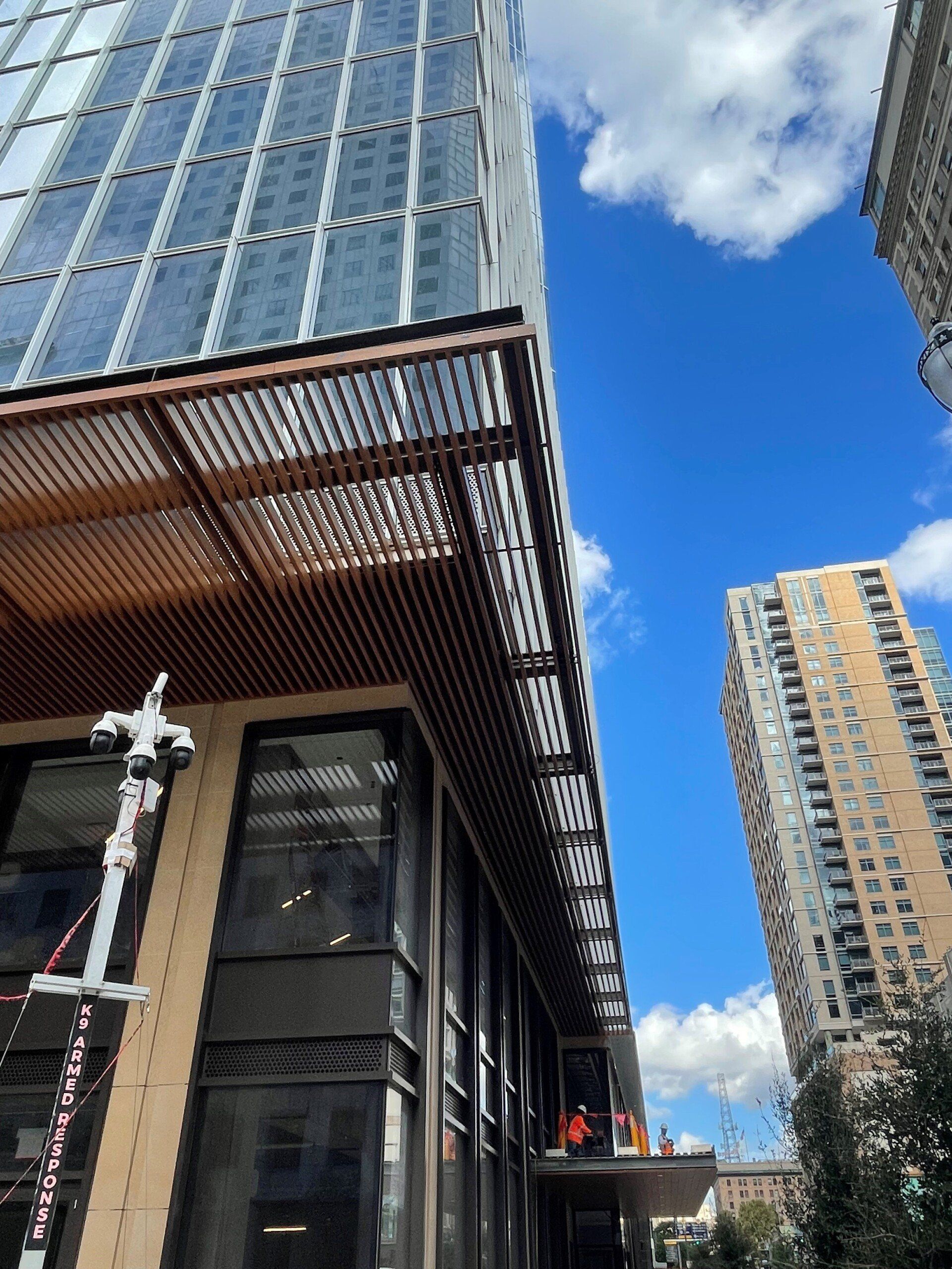 Looking up at a tall building with a blue sky in the background