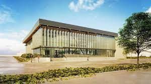 an artist 's impression of a large building with a lot of windows and a tree in front of it .