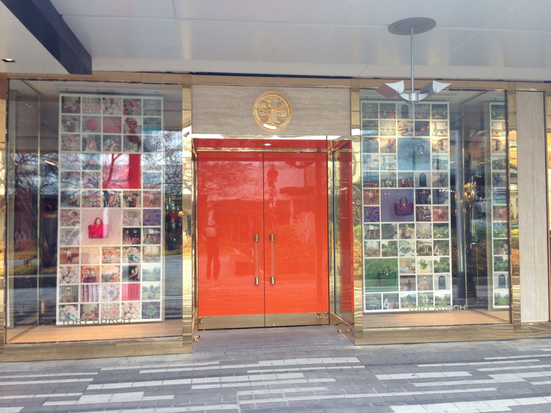 A store front with a red door and a clock on top