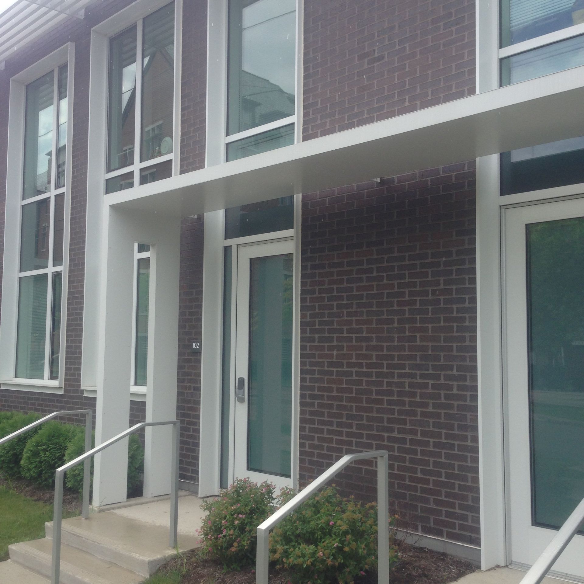 A brick building with a white canopy over the entrance